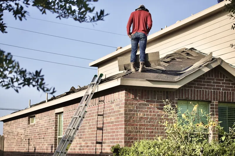 Professional roofer working on a residential roof in Country Squire Acres